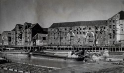 Barges moored alongside High Street warehouses no's, 18, 19 and 20